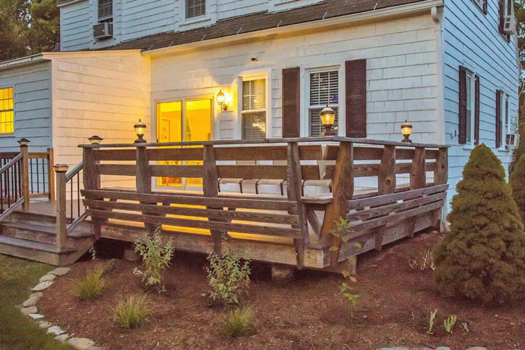 Wooden deck off of the back of the cottage.